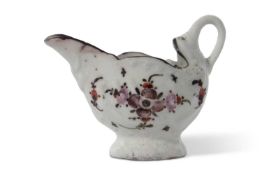 A Lowestoft porcelain dolphin ewer decorated with an early polychrome design of flowers beneath a