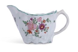 A Lowestoft porcelain jug c1780 of Chelsea ewer shape with polychrome decoration of flowers below