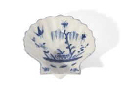 An early Lowestoft porcelain scallop shell dish c.1759 painted in a pale tone of blue with flowering