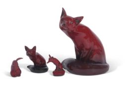 A large Royal Doulton flambe model of a fox signed by Noke together with two smaller examples and