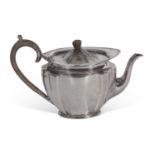 George V teapot of fluted oval tapering form with raised apron, tureen finial and handle, max height
