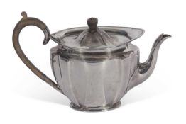 George V teapot of fluted oval tapering form with raised apron, tureen finial and handle, max height