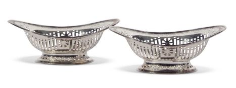 Pair of late Victorian oval bonbon dishes with slot pierced, foliate decoration, pierced oval bases,