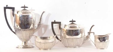 George V four-piece tea and coffee service of half-fluted tapering oval form. Comprising a coffee