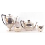 George V four-piece tea and coffee service of half-fluted tapering oval form. Comprising a coffee