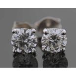 A pair of Diamond stud earrings each claw set with a round brilliant cut diamond. Total diamond