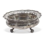 Edwardian shaped circular fruit bowl having pierced wavey rim dished centre and supported on three