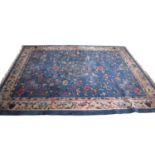Early 20th century Peking wool carpet decorated with stylised foliage on a blue centre with a pale