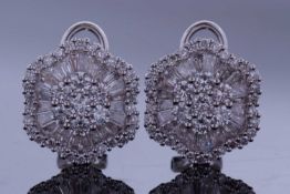 Pair of diamond cluster earrings, the centres with 7 round brilliant cut diamonds raised above a
