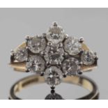 18ct gold diamond cluster ring, a flowerhead design featuring seven round brilliant cut diamonds