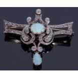 Opal and diamond set brooch centring a cabochon opal within an openwork scroll design set with