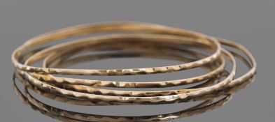 Four mid-grade yellow metal bangles with engraved detail, 19.2gms g/w