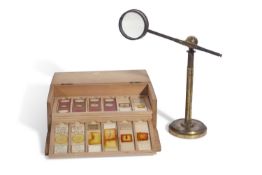 A case containing nine trays of 19th century microscope slides to include examples containing