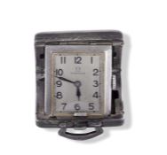 Small silver folding Omega travel clock with hallmark on inside of case, dial stamped 'Omega' and