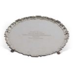 Elizabeth II shaped circular salver with 'Chippendale' edge supported on four paw feet, presentation
