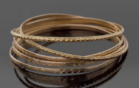 Five yellow metal bangles, all unmarked, test between 9-14ct, 40.3gms