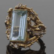 18ct gold large designer made aquamarine and diamond dress ring, the rectangular step cut aquamarine