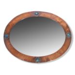 Late 19th century oval wall mirror in the Arts & Crafts style, the frame with planished copper mount