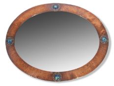 Late 19th century oval wall mirror in the Arts & Crafts style, the frame with planished copper mount