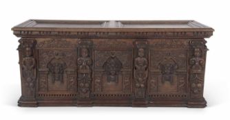Large 17th-century continental oak coffer with two panelled lid opening to an interior with fitted