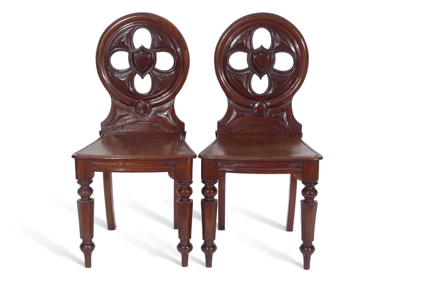 Pair Victorian mahogany hall chairs with circular pierced back with central shield decoration over