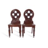 Pair Victorian mahogany hall chairs with circular pierced back with central shield decoration over