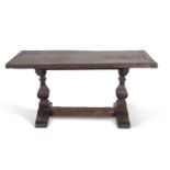 17th Century style oak refectory table with thick cleated board top raised on two shaped columns and