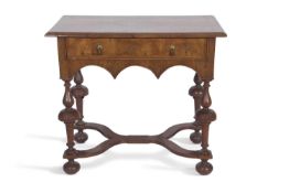 William and Mary style walnut lowboy with a single frieze drawer raised on turned columns and X-
