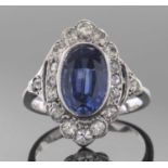 Sapphire and diamond ring, the oval faceted sapphire 10mm x 7mm approx, bezel set within a small