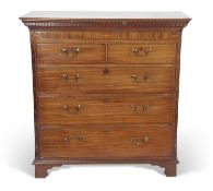 George III mahogany chest of drawers with moulded and dental cornice over a band with inlaid shell