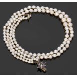Double row of graduated cultured pearls, 3-7mm diam, to a garnet and seed pearl set clasp, 20cm long