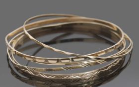 Five 9ct gold bangles with engraved detail, (non-matching), 14.9gms