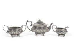 George III Scottish silver tea set of compressed circular form with gadrooned rims, half-fluted