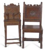 17th Century and later oak hall chair with panelled back and central carved floral medallion over