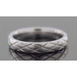 A platinum band engraved with a geo-metric design, 5.2gms finger size J