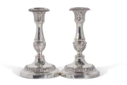 A pair of George IV candlesticks with baluster stem, and detachable nozzles. The loaded bases with