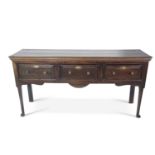 18th century oak dresser base with three drawers with brass knob handles raised on tapering circular