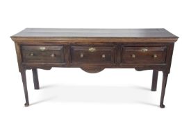 18th century oak dresser base with three drawers with brass knob handles raised on tapering circular