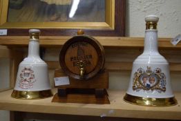 TWO ROYAL COMMEMORATIVE WADE WHISKY BELLS (WITH CONTENTS), TOGETHER WITH A MINIATURE OAK COGNAC