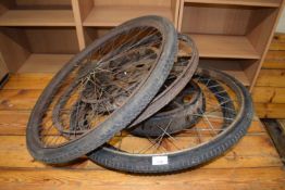 Two vintage motorcycle wheels plus one other