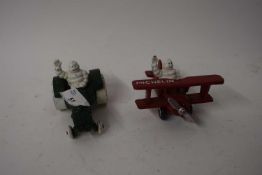 Two small cast iron Michelin advertising figures, one formed as a tractor, the other a plane