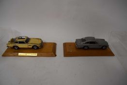 Two Danbury Mint James Bond Aston Martin DB5 models in different colour variations, both in