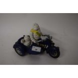 Michelin cast iron advertising figure group modelled as two figures in a motorcycle and side car