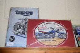 Two thin metal signs 'Triumph' and 'Route 66'