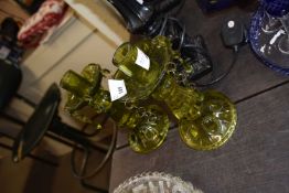 Pair of green glass candlesticks with moulded decoration and droplets from the drip pan, 23cm high