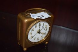 SMALL TRAVELLING ALARM CLOCK IN BASE METAL CASE