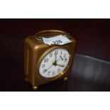 SMALL TRAVELLING ALARM CLOCK IN BASE METAL CASE