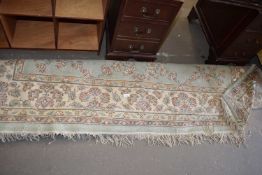 20TH CENTURY WOOL FLOOR RUG DECORATED WITH FLORAL DESIGN ON A BEIGE AND GREEN BACKGROUND