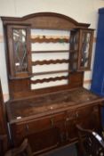 EARLY 20TH CENTURY OAK DRESSER, THE TOP SECTION WITH TWO LEAD GLAZED DOORS OVER A BASE WITH TWO