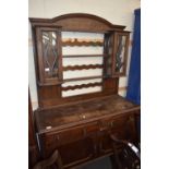 EARLY 20TH CENTURY OAK DRESSER, THE TOP SECTION WITH TWO LEAD GLAZED DOORS OVER A BASE WITH TWO